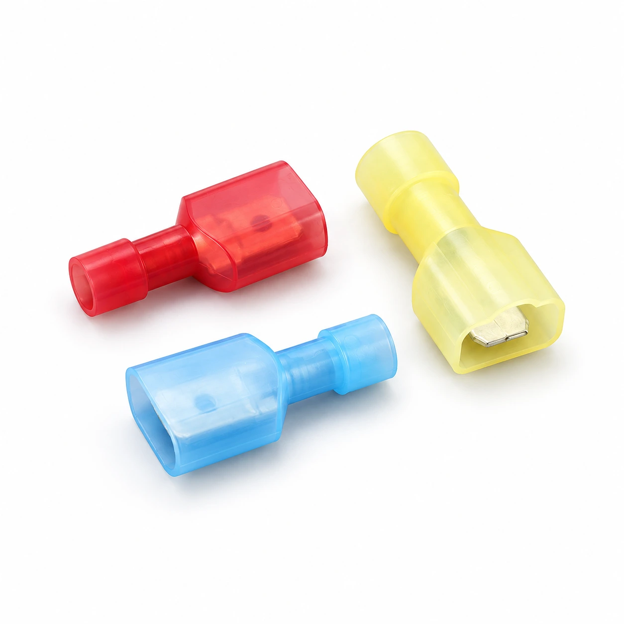 Red, blue and yellow fully insulated nylon male disconnect terminals with rectangular mating shrouds, illustrative recreation of the original TONFUL catalogue photograph